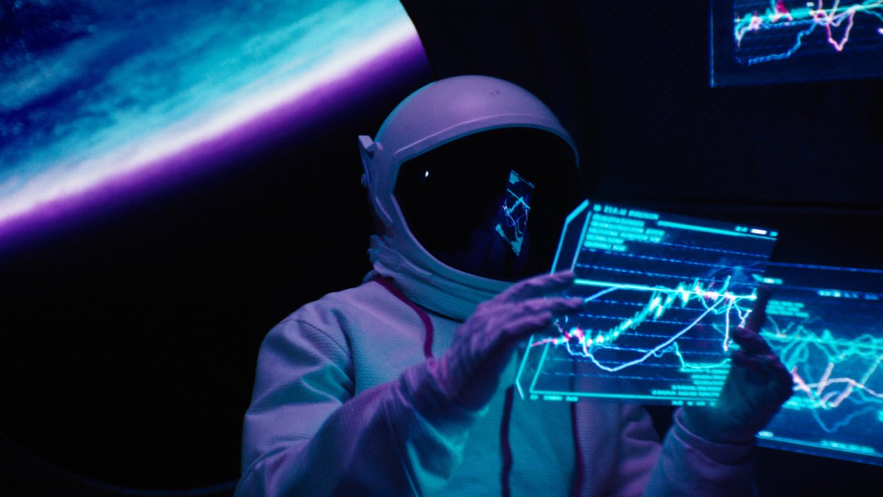 An operator reading a holographic chart panel in orbit